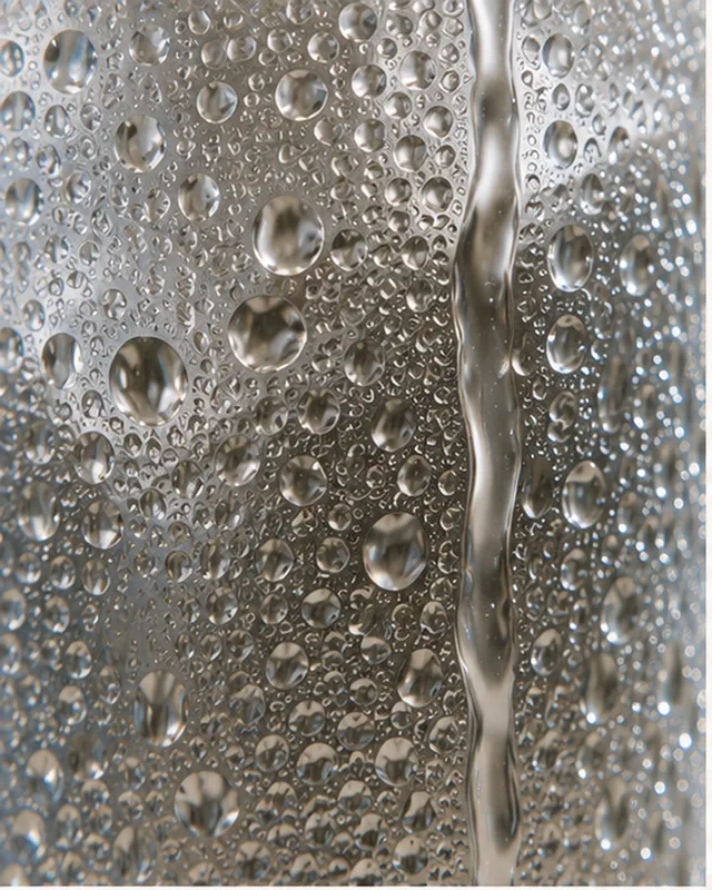 Macro detail of condensation on a cold glass surface.